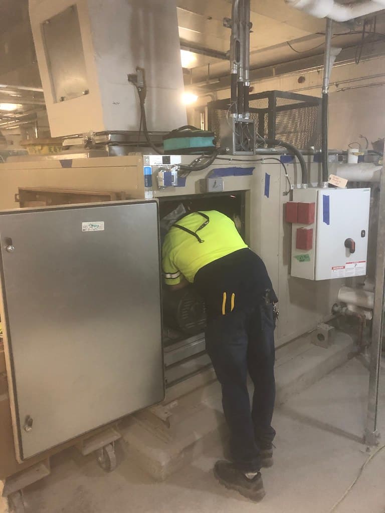 Electrician servicing an electrical control panel